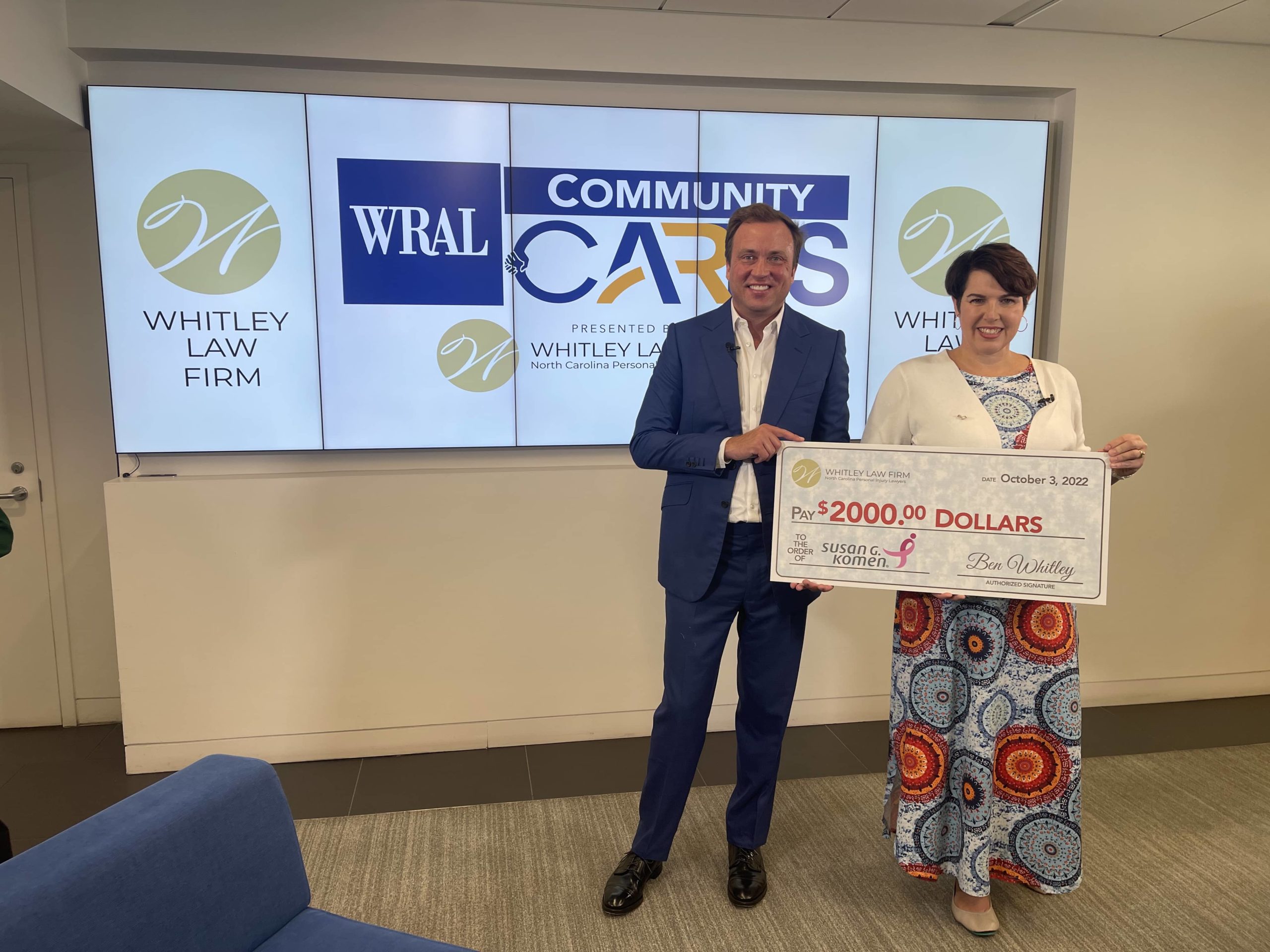 Ben Whitley of the Whitley Law Firm presenting a donation check to Kimberly Burrows, Susan G. Komen State Executive Director of North and South Carolina