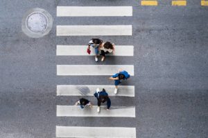 aerial view of pedestrians walking in a crosswalk