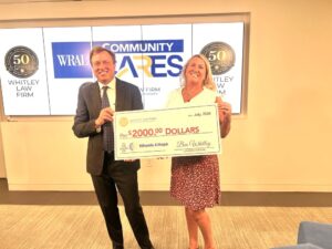 Attorney Ben Whitley, of Whitley Law Firm, presents a check for $2,000 to Wheels4Hope