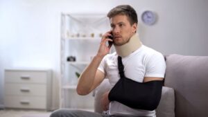 Man in Arm Sling and Foam Cervical Collar