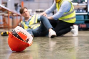 Two men after a workplace accident. You can discuss your situation with a Kinston workplace injury lawyer.