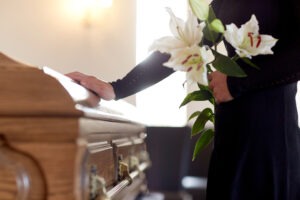 A woman at a funeral. Learn about the statute of limitations for wrongful death cases in North Carolina.