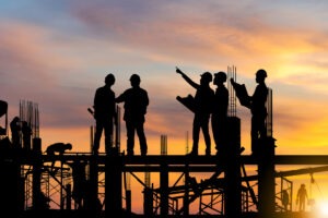 Construction workers at sunset. Discuss your legal situation with a Chapel Hill construction accident lawyer.