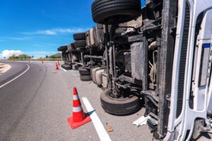 An overturned truck is on the road. Who can be sued in a truck accident case?