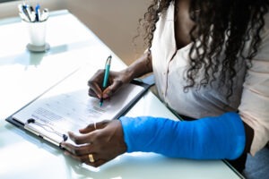 Woman filling out a worker insurance compensation form