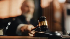 A judge banging a gavel. Learn about how long a motorcycle accident lawsuit takes in North Carolina.